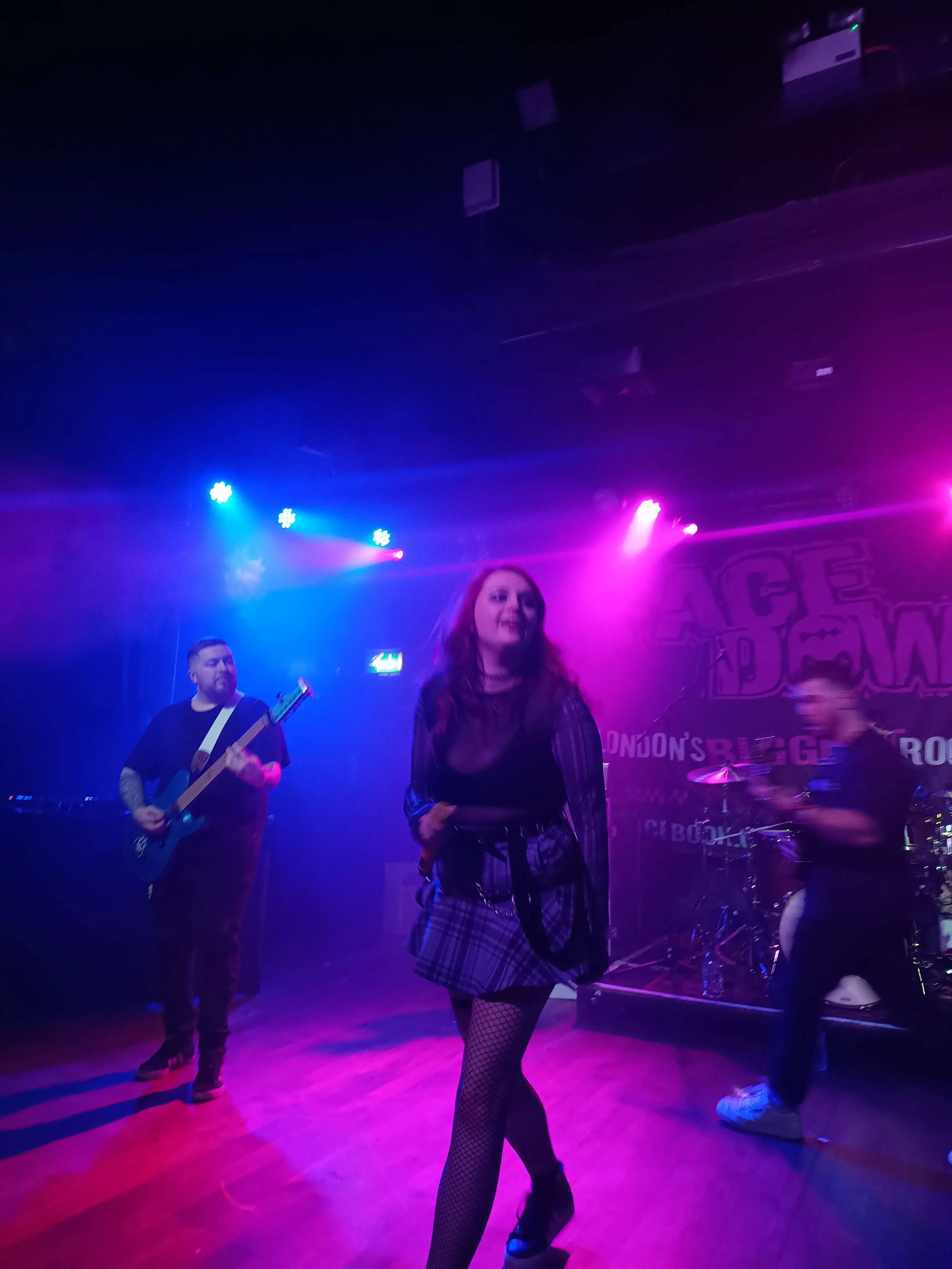 various performers doing their thing on stage in dramatic colourful lighting