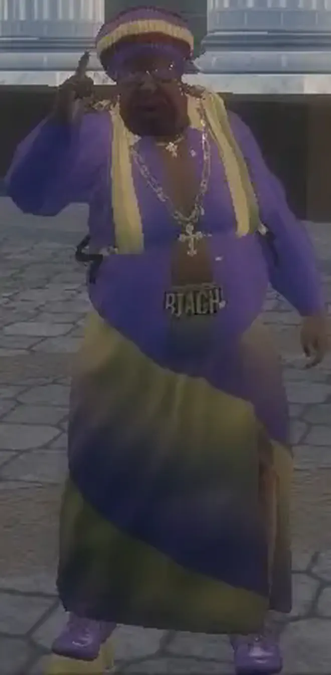 My Saints Row 2 protagonist, a fat black man with pink facial hair and a purple and yellow robe, he has a cross pendant around his neck and a “BIATCH” plate on his crotch