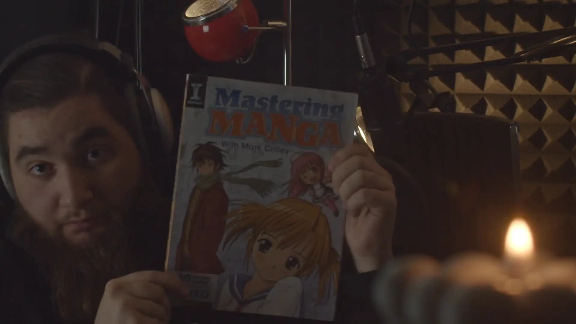 Cheecken holding up the Mark Crilley book 'Mastering Manga'.