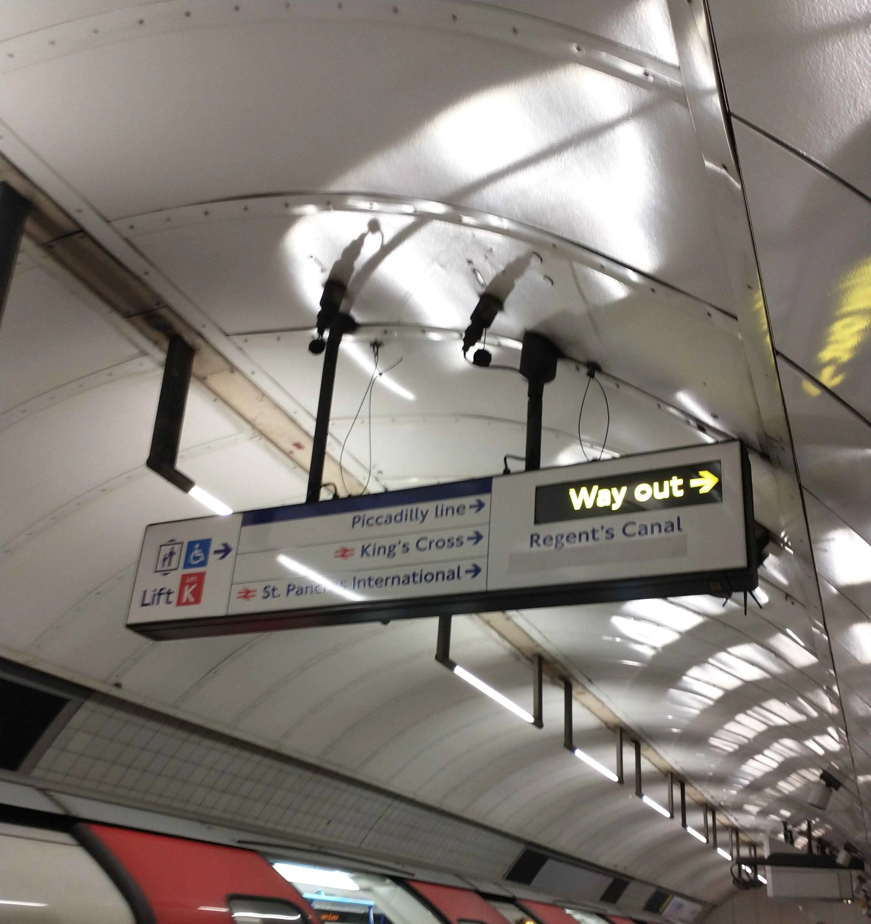 A sign showing the Way Out to the right.