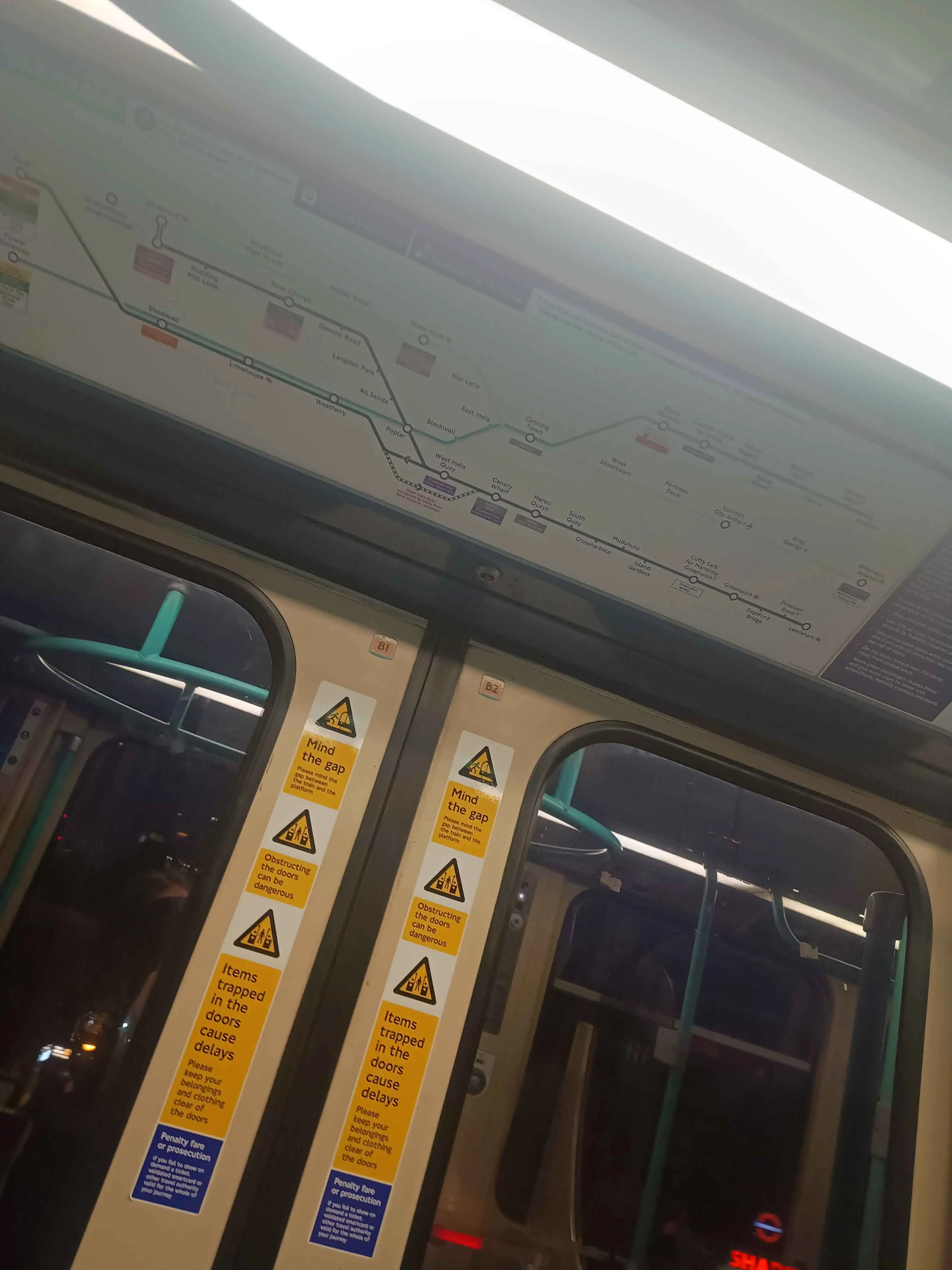 Trainline map above the automated doors of a train.